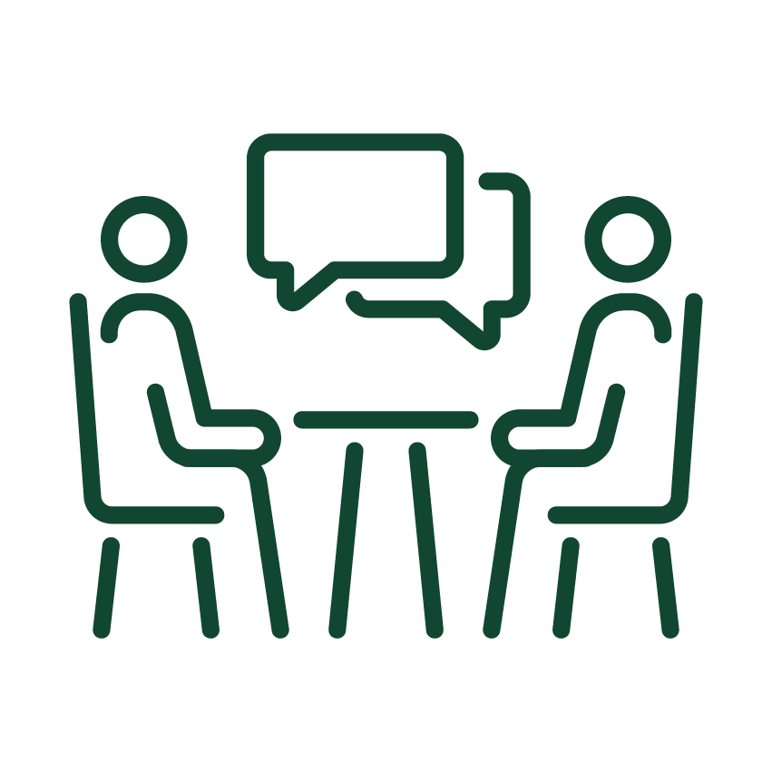 Outline icon showing two people sitting opposite each other at a table with overlapping speech bubbles indicating conversation or interview.